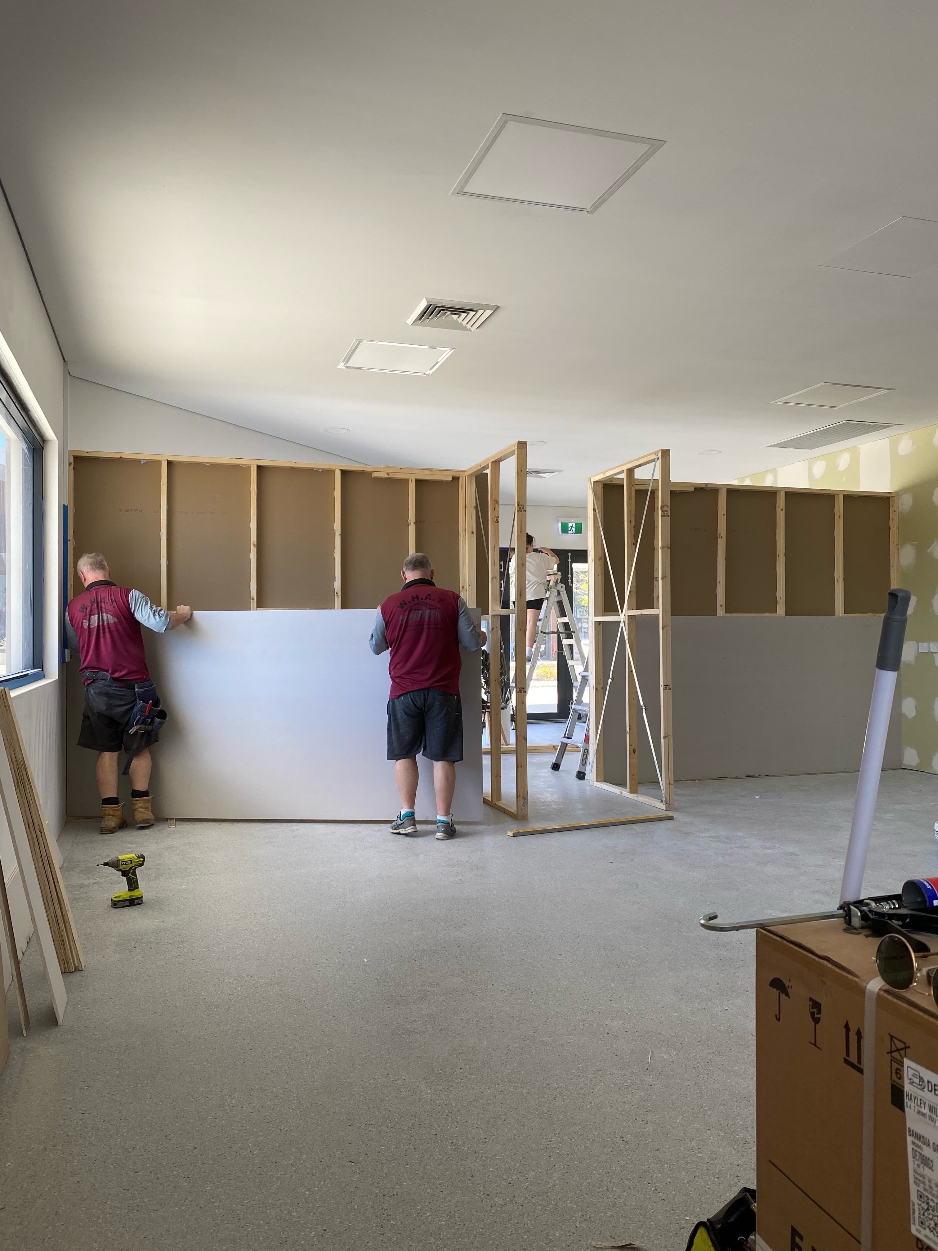 Family members helping build out the interior of Toby's Dog Grooming salon